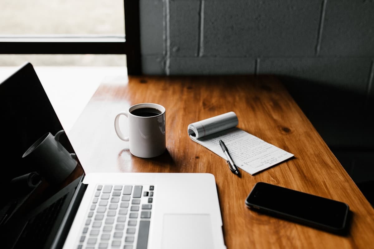 Writing desk with a laptop and notebook